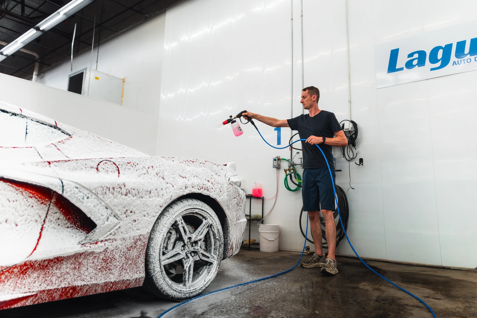 Marshall detailing the Corvette in the wash bay